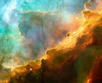 HST WF Camera view of gas and dust clouds in the Swan Nebula; dust-rich regions shown in orange and black.